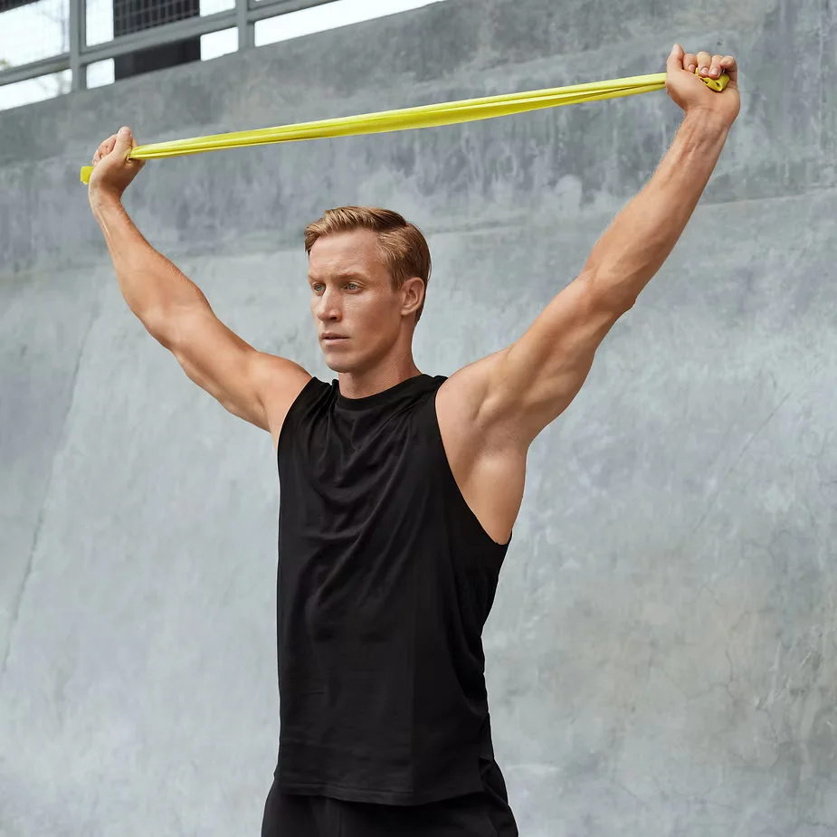 Active man stretching with arms raised at sunrise | Restoration Health 365 in Jericho NY