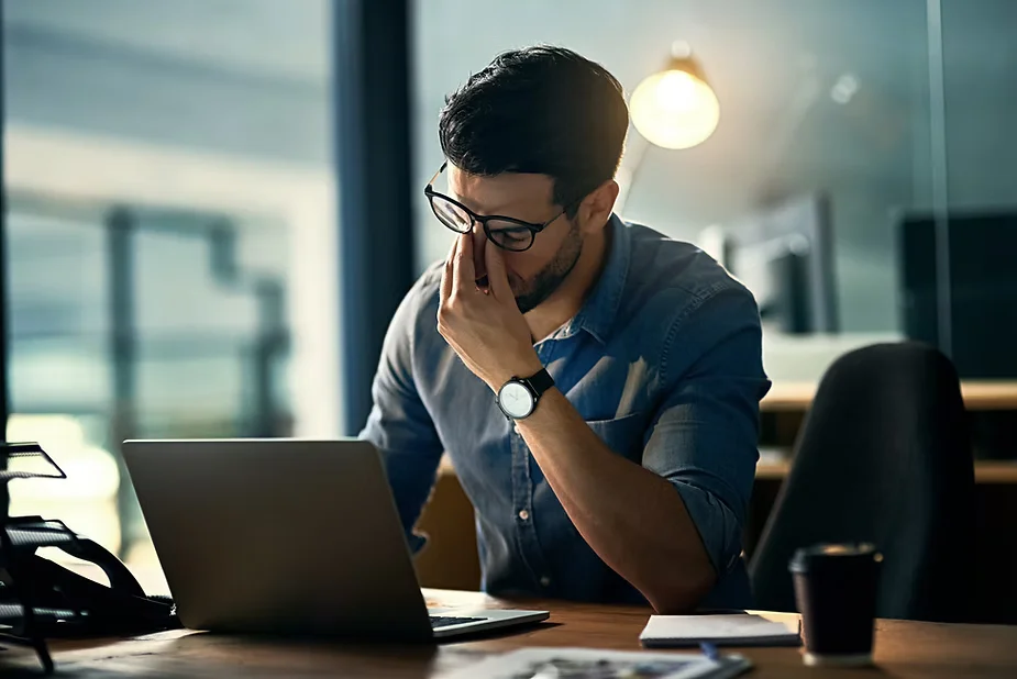 Man experiencing work-related stress at his desk | Restoration Health 365 in Jericho NY