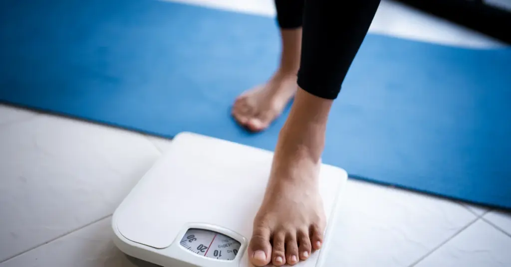 Feet stepping on scale for weight management | Restoration Health 365 in Jericho NY